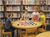 Kids at a large checkerboard
