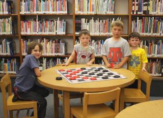 Kids at a large checkerboard